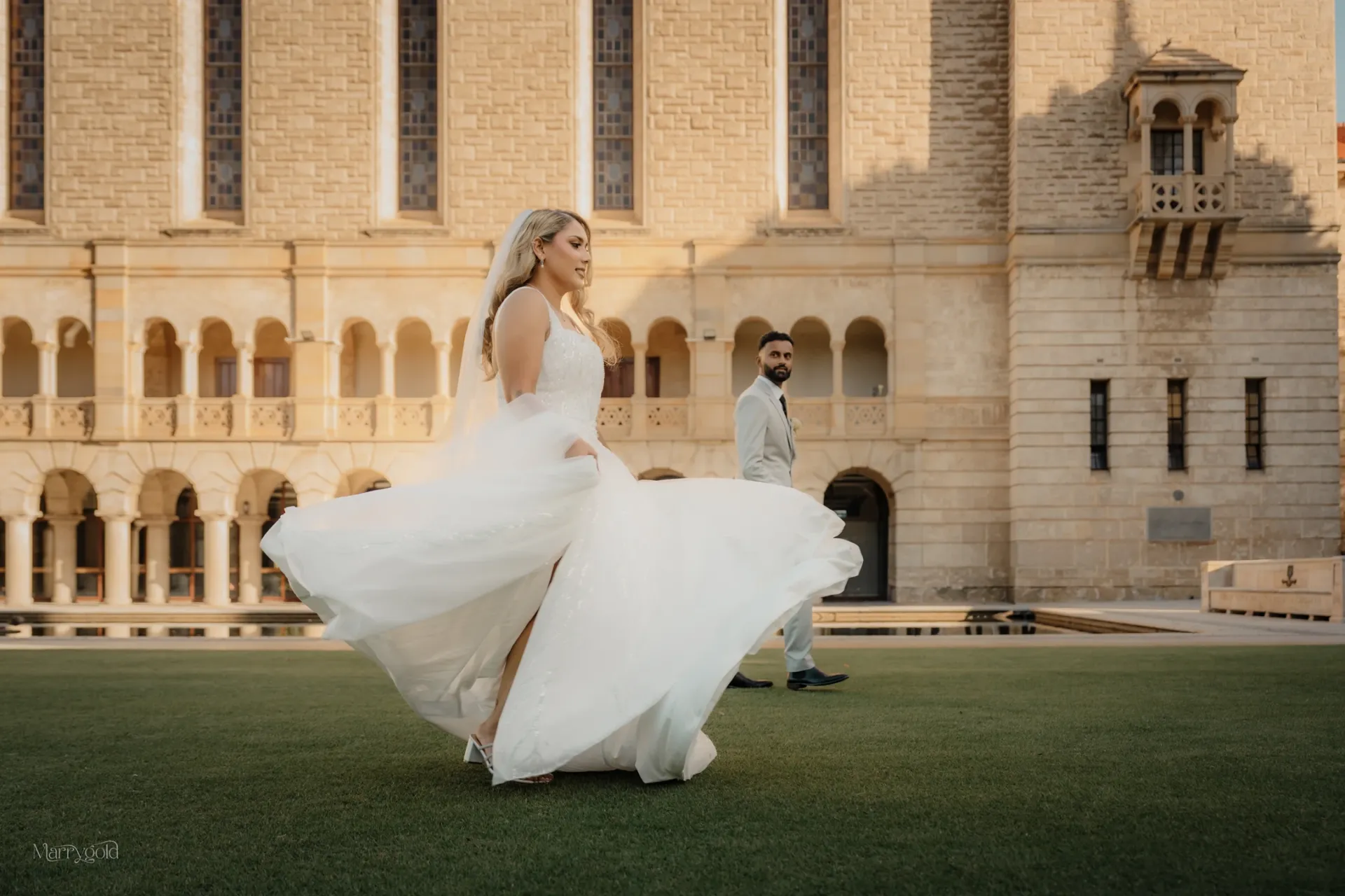 perth bride twirling white gown lawn arched building Marrygold Weddings #1 Wedding photography and videography in Perth