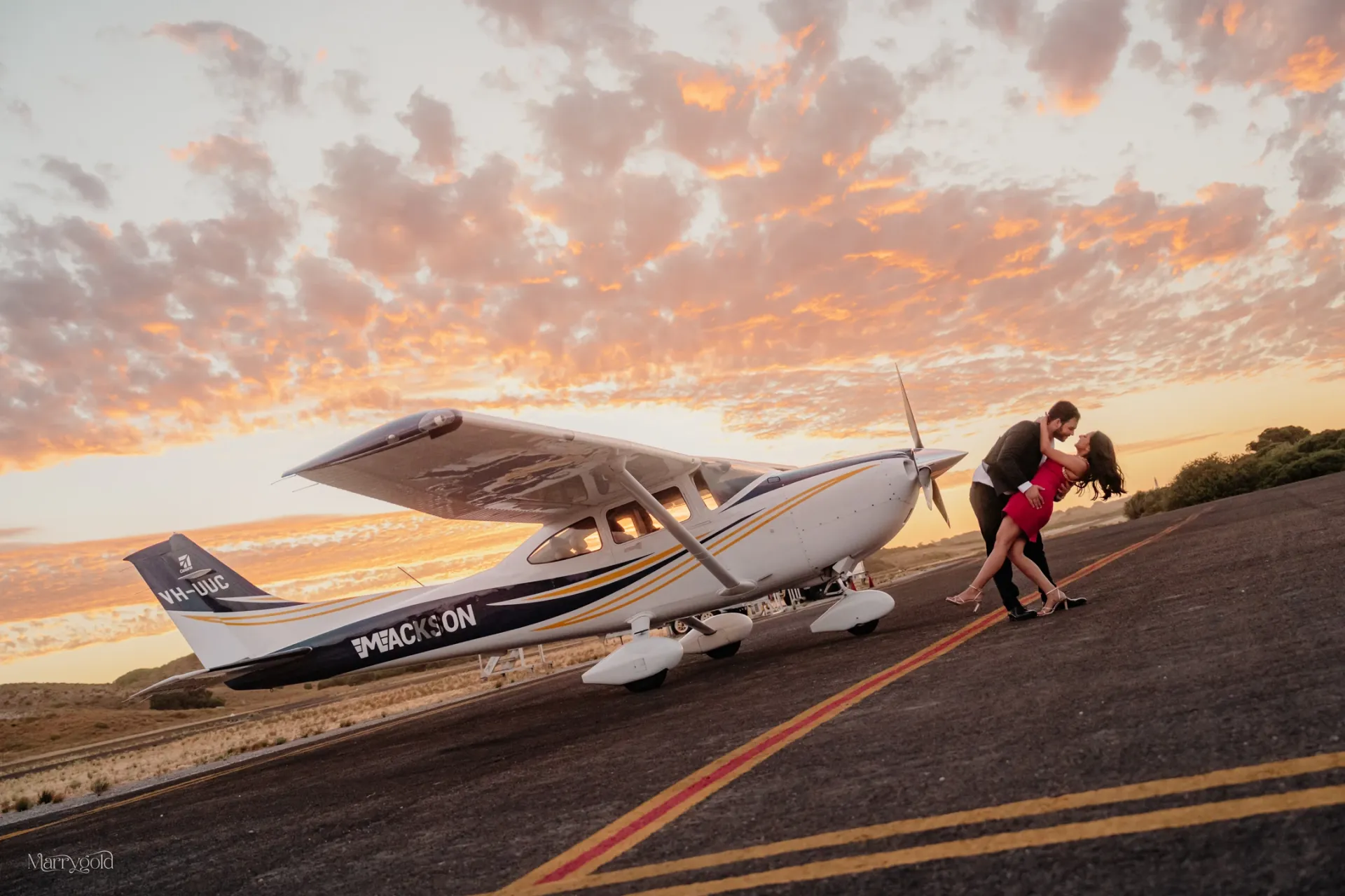couple dip kiss small plane sunset airstrip golden hour Marrygold Weddings #1 Wedding photography and videography in Perth